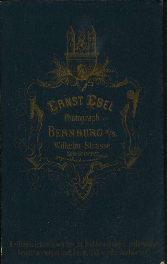 Reverse of a monochrome photographic portrait from between 1865 and the 1920s taken by Ernst Ebel, Wilhelm-Straße, Bernburg a. S.