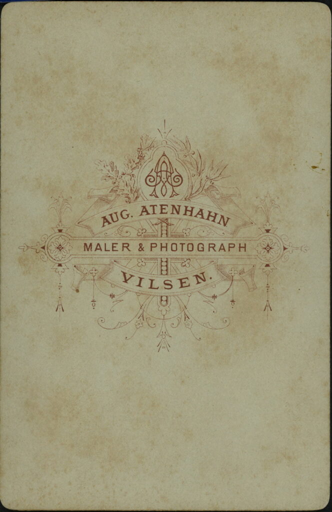 Reverse of a monochrome photographic portrait from between 1865 and the 1920s taken by Aug. Atenhahn, Vilsen