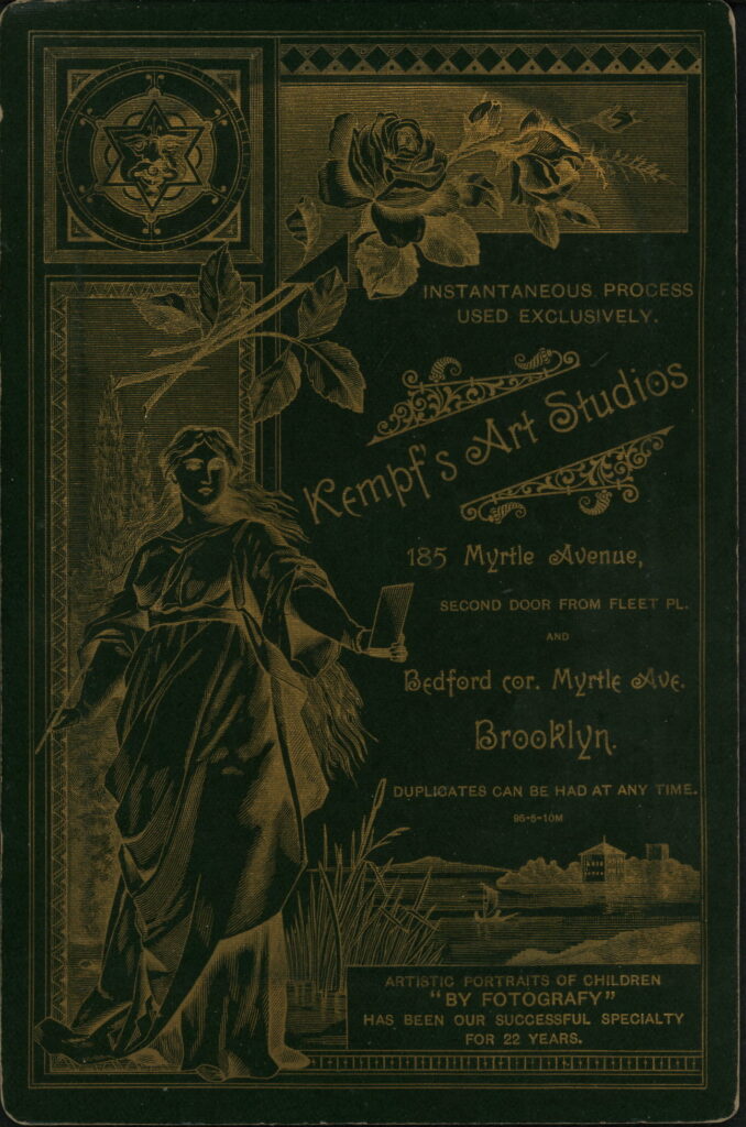 Reverse of a monochrome photographic portrait from between 1865 and the 1920s taken in Kempf's Art Studios, 185 Myrtle Avenue, Brooklyn, NY