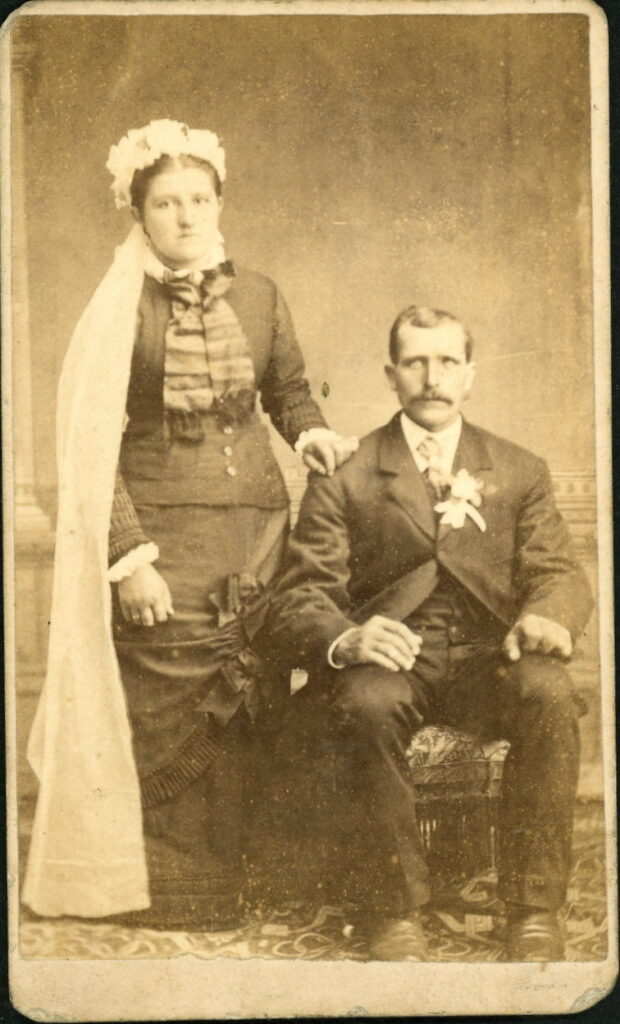 A monochrome photographic portrait from between 1865 and the 1920s taken by M. W. Newcomb, Marysville, Kansas