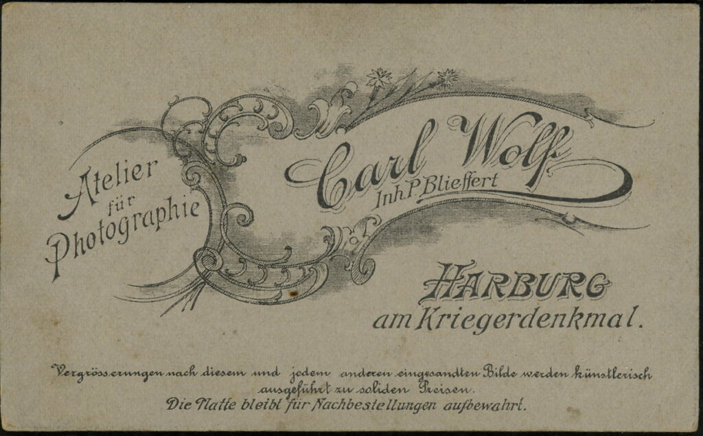 Reverse of a monochrome photographic portrait from between 1865 and the 1920s taken by Carl Wolf, inh. P. Blieffert, am Kreigerdenkmal, Harburg