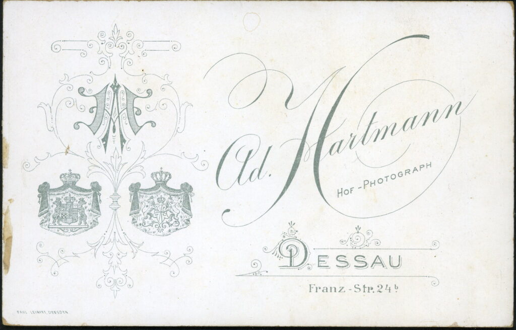 Reverse of a monochrome photographic portrait from between 1865 and the 1920s taken by Ad. Hartmann, Franz-Straße 24b, Dessau