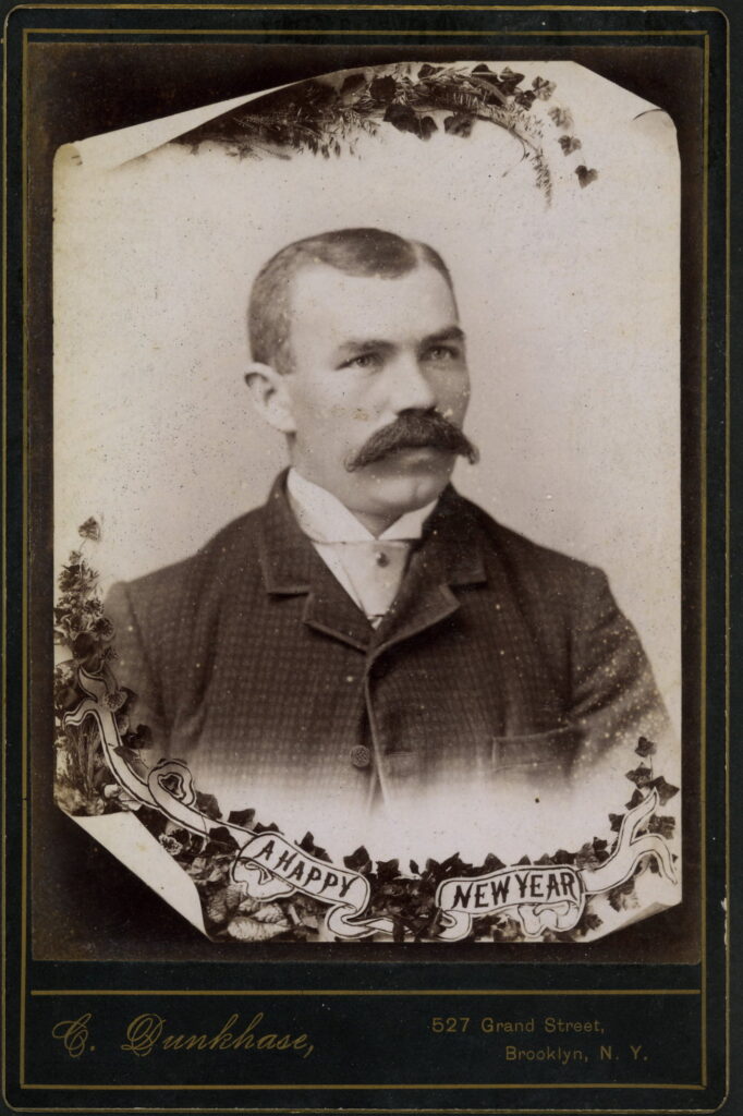 A monochrome photographic portrait from between 1865 and the 1920s taken by C. Dunkhase, 527 Grand Street, Brooklyn E.D.