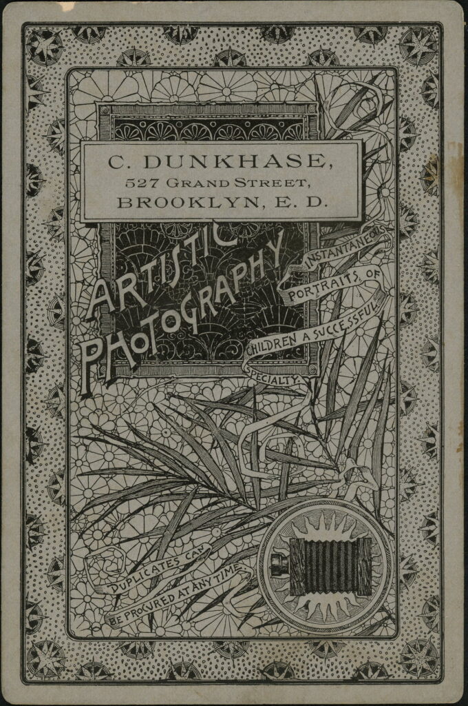 Reverse of a monochrome photographic portrait from between 1865 and the 1920s taken by C. Dunkhase, 527 Grand Street, Brooklyn E.D.