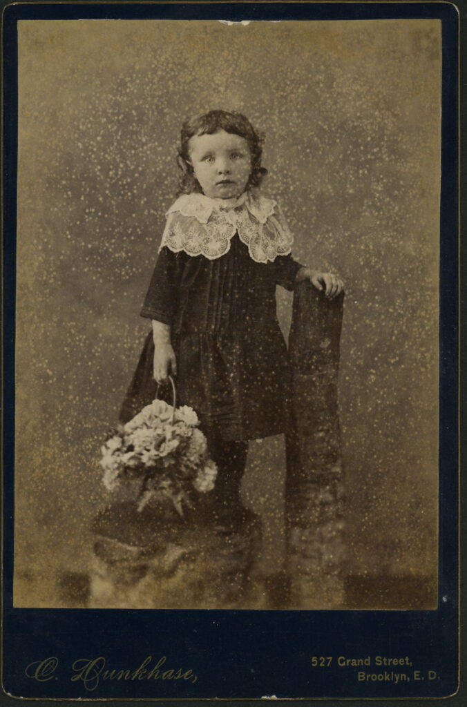 A monochrome photographic portrait from between 1865 and the 1920s taken by C. Dunkhase, 527 Grand Street, Brooklyn E.D.