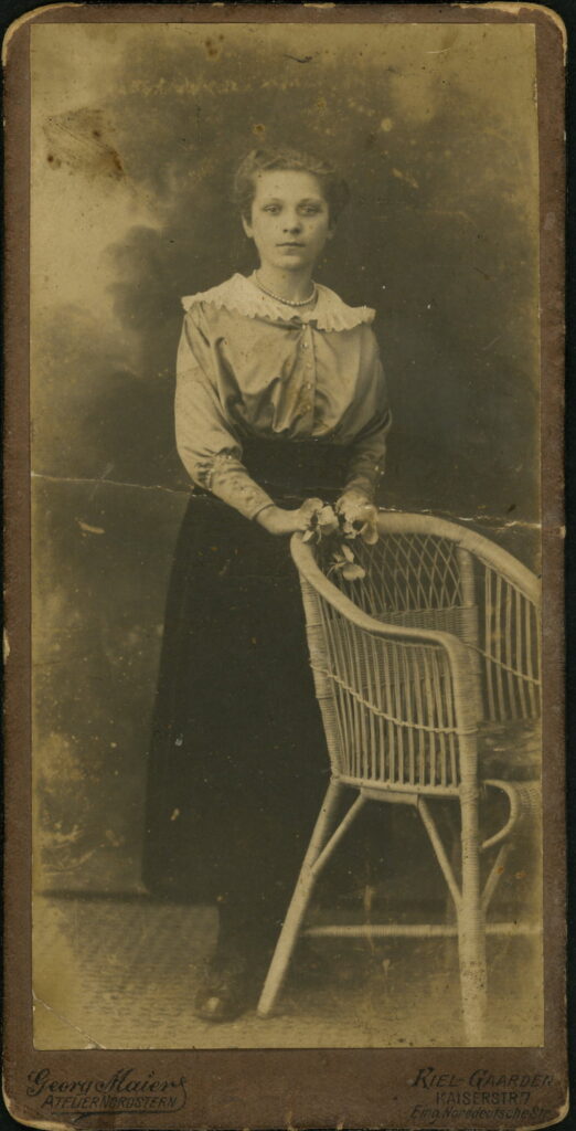 A monochrome photographic portrait from between 1865 and the 1920s taken by Georg Maier in Atelier Nordstern, Kaiserstraße 7, Kiel-Gaarden and dated 1918