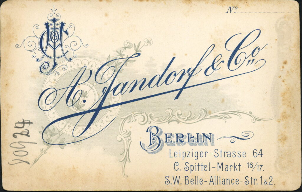 Reverse of a monochrome photographic portrait from between 1865 and the 1920s taken by A. Jandorf, Leipziger-Straße 64, Berlin, Spittel-Markt 16 / 17, Berlin and Belle-Alliance-Straße 1 & 2, Berlin